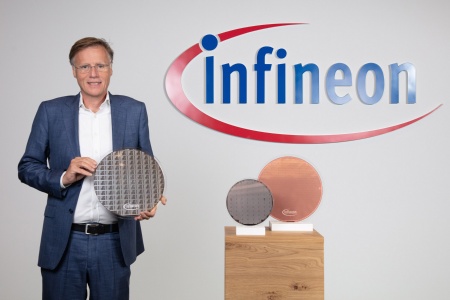 Infineon CEO Jochen Hanebeck holds a new 300-millimetre silicon-based thin wafer in his hand.